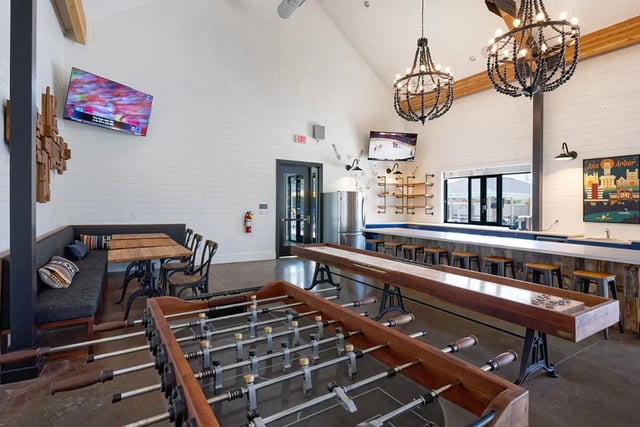 Foosball shuffleboard bar stools TVs playing area at University Trails Apartments in Ann Arbor Student Accommodation
