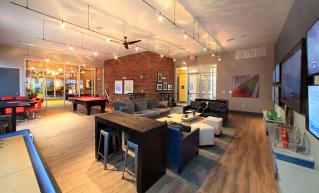 Pool tables shuffleboard couches and TVs communal area at University Edge Apartments in Akron Student Accommodation