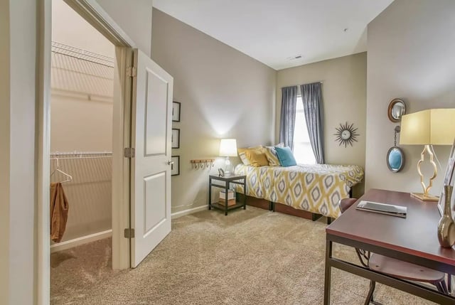 Bed desk closet and open door bedroom at University Edge Apartments in Akron Student Accommodation
