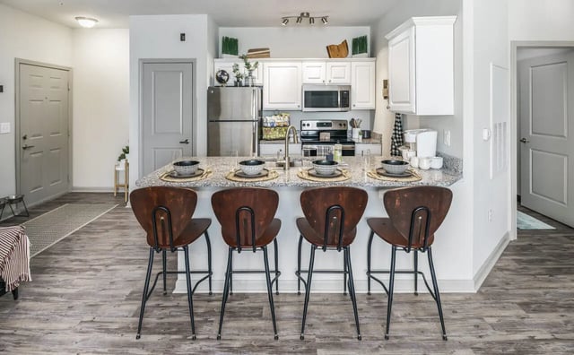 Kitchen island with stools and appliances kitchen at The Summit at Coates Run in Athens Student Accommodation