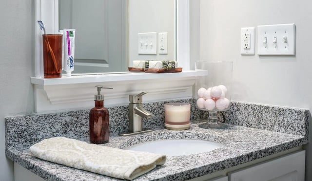 Sink soap dispenser candle bath bombs bathroom at The Summit at Coates Run in Athens Student Accommodation