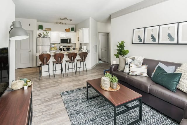 Sofa and kitchen island with stools living room at The Summit at Coates Run in Athens Student Accommodation