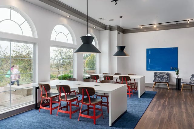 White tables with red chairs study area at The Summit at Coates Run in Athens Student Accommodation