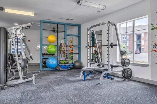 Gym equipment weights stability balls fitness room at The Rendezvous Apartments in Edmond Student Accommodation