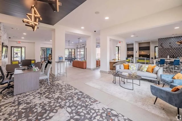 Reception desk pool table and lounge area living room at The Rendezvous Apartments in Edmond Student Accommodation