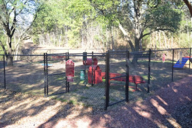 Dog park with red benches and play structure exterior at Hillside Commons in Tuscaloosa Student Accommodation