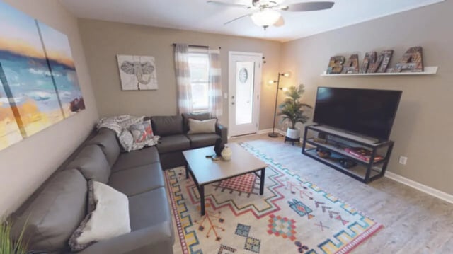 L-shaped sofa coffee table colorful rug living room at Hillside Commons in Tuscaloosa Student Accommodation