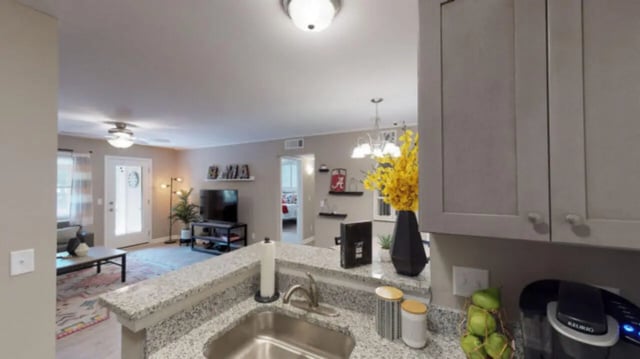 Kitchen counter sink and cabinets living area view living room. at Hillside Commons in Tuscaloosa Student Accommodation