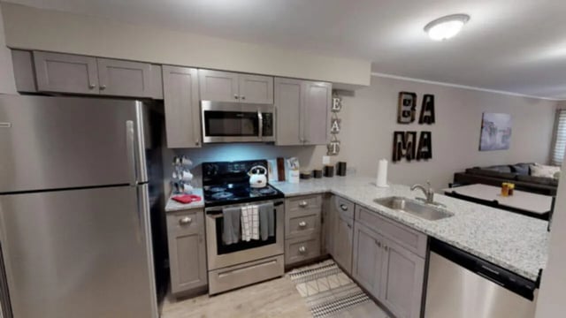 Stainless steel refrigerator stove cabinets and sink kitchen at Hillside Commons in Tuscaloosa Student Accommodation