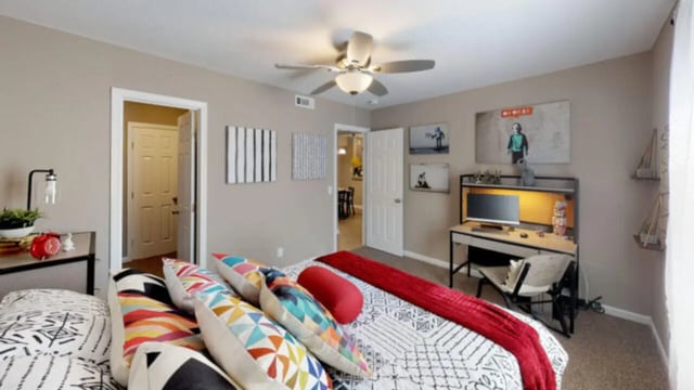 Bed with colorful pillows desk computer study bedroom at Hillside Commons in Tuscaloosa Student Accommodation