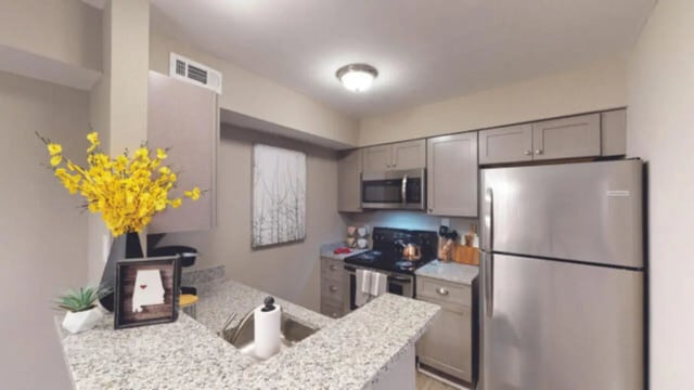 Kitchen with granite counter stainless steel appliances kitchen at Hillside Commons in Tuscaloosa Student Accommodation
