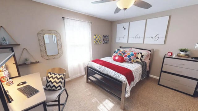Desk chair bed dresser and wall art bedroom at Hillside Commons in Tuscaloosa Student Accommodation