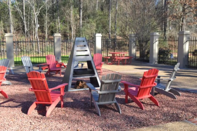 Adirondack chairs around a fire pit outdoor area at Hillside Commons in Tuscaloosa Student Accommodation