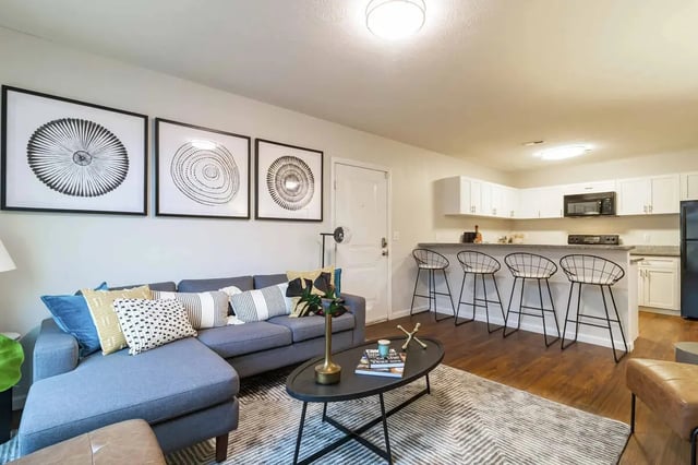 Sofa artworks and kitchen bar stools living room at PPG East Village in Columbus Student Accommodation