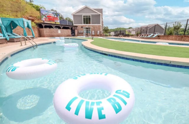 Pool with floats and lounge chairs pool area at Knox Ridge in Knoxville Student Accommodation