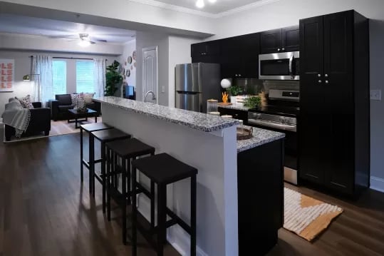 Kitchen island with bar stools living room and kitchen at Knox Ridge in Knoxville Student Accommodation