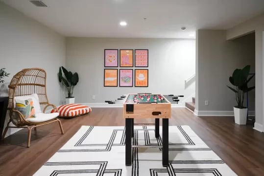 Foosball table rattan chair posters living room at Knox Ridge in Knoxville Student Accommodation