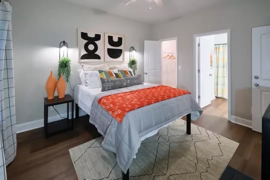 Bed with orange throw artwork bedside table bedroom at Knox Ridge in Knoxville Student Accommodation