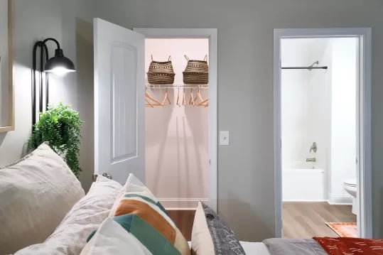 Closet with baskets and empty hangers bathroom visible bedroom at Knox Ridge in Knoxville Student Accommodation