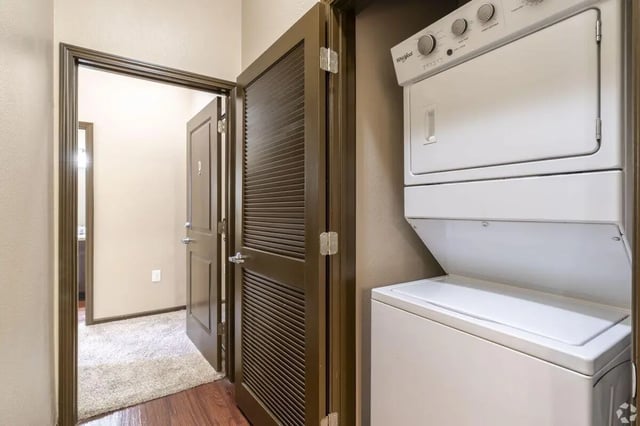 Stacked white washer dryer and doors laundry area at The Republic in Reno Student Accommodation