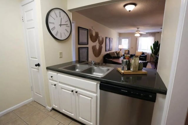 Double sink black countertop white cabinets kitchen at Market 100 in Statesboro Student Accommodation
