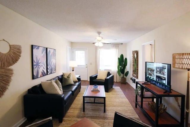 Black leather sofa coffee table TV living room at Market 100 in Statesboro Student Accommodation