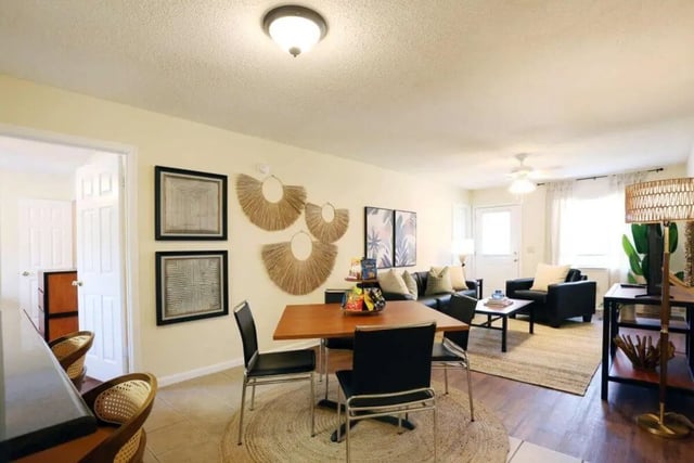 Dining table chairs sofa coffee table living room at Market 100 in Statesboro Student Accommodation