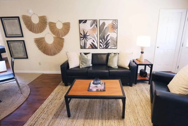 Black sofa coffee table artwork hanging decor living room at Market 100 in Statesboro Student Accommodation