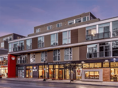 Modern building with balconies and storefronts exterior at The View on High in Columbus Student Accommodation