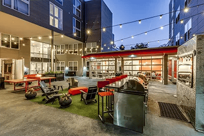 Courtyard with grills seating and string lights exterior at The View on High in Columbus Student Accommodation