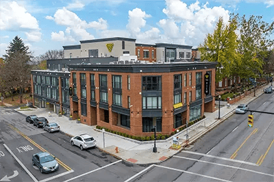 Brick building with cars on street exterior at The View on Pavey Square in Columbus Student Accommodation