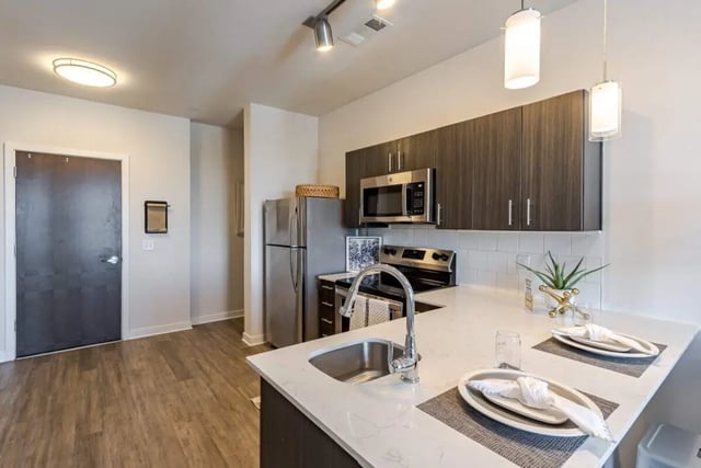 Modern kitchen with stainless steel appliances and dining area Kitchen at Hoffler Place in Charleston Student Accommodation