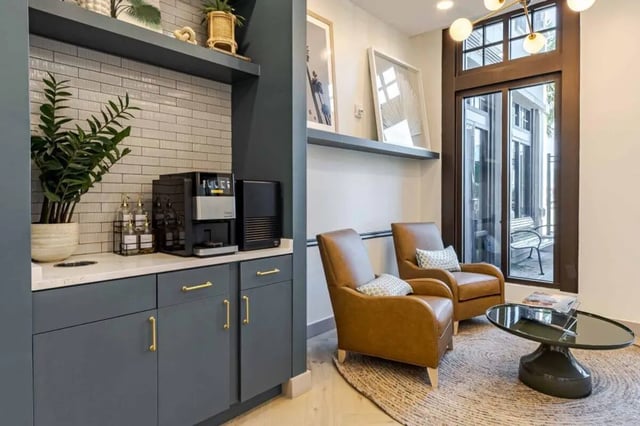 Coffee maker plant chairs coffee table living area at Hoffler Place in Charleston Student Accommodation