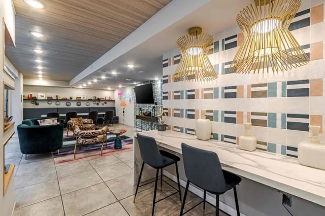 Seating area with patterned chairs and bar area lounge at Hoffler Place in Charleston Student Accommodation