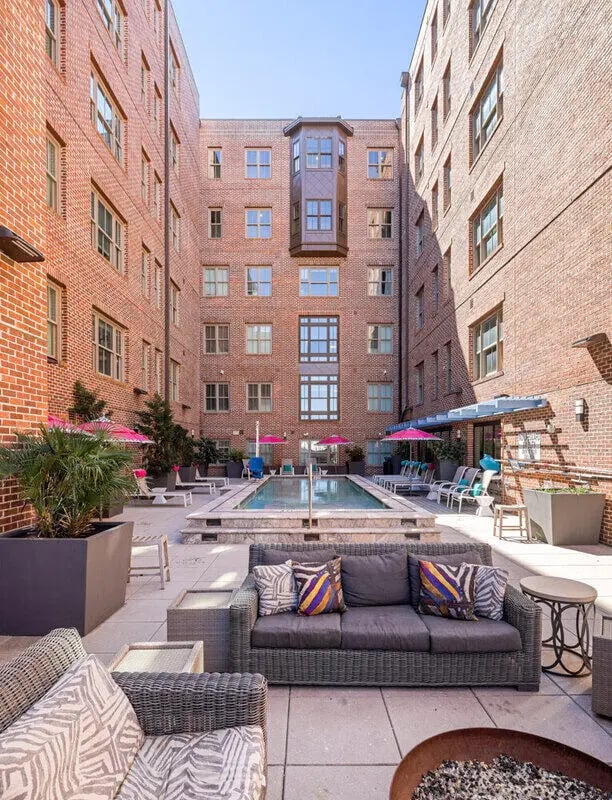 Sofa with cushions pool and patio area courtyard at Hoffler Place in Charleston Student Accommodation