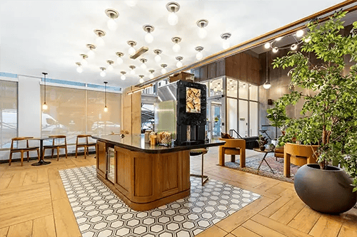 Wooden island coffee maker seating area lounge at HERE Pittsburgh in Pittsburgh Student Accommodation
