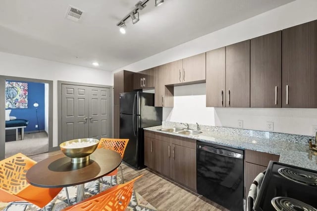 Kitchen with dining table and chairs kitchen at Holleman Crossing in College Station Student Accommodation