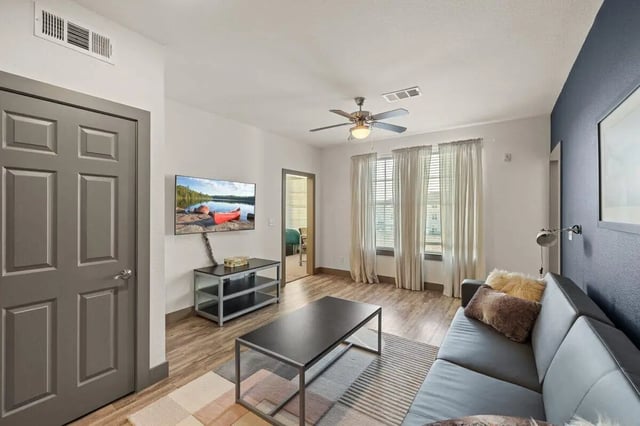 Sofa coffee table TV rug living room at Holleman Crossing in College Station Student Accommodation