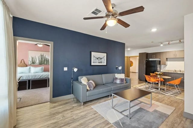 Sofa coffee table kitchen with chairs living room at Holleman Crossing in College Station Student Accommodation