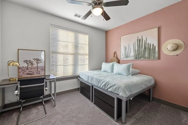 Bed desk ceiling fan art wall and hat bedroom at Holleman Crossing in College Station Student Accommodation