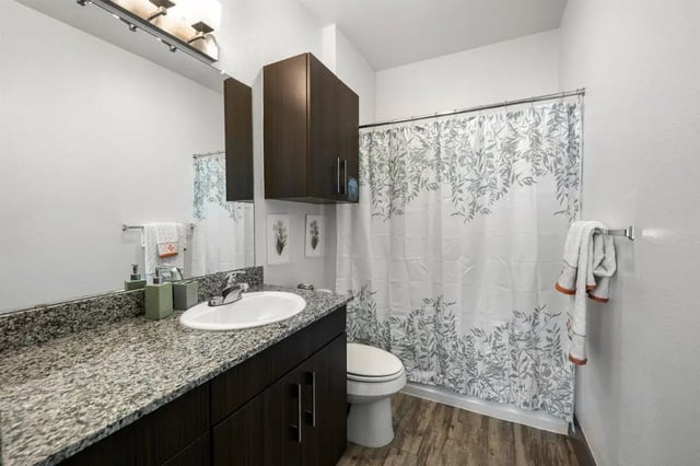 Sink toilet shower curtain bathroom at Holleman Crossing in College Station Student Accommodation