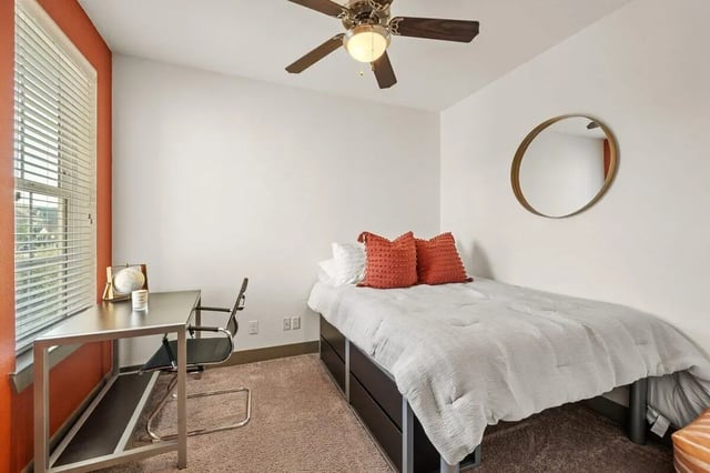 Bed desk chair and mirror bedroom at Holleman Crossing in College Station Student Accommodation