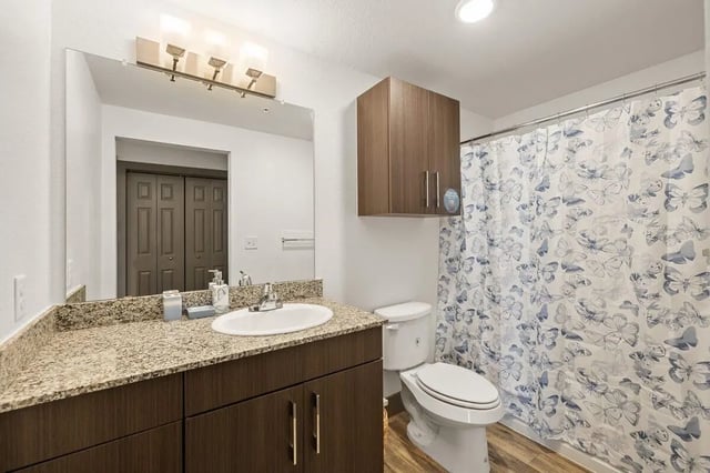 Toilet sink shower curtain cabinets bathroom at Holleman Crossing in College Station Student Accommodation