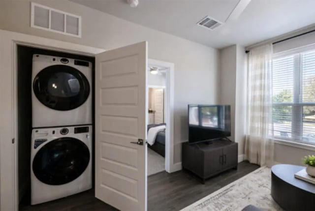 Stacked washer dryer TV and window living room at The Carlton House in Lubbock Student Accommodation