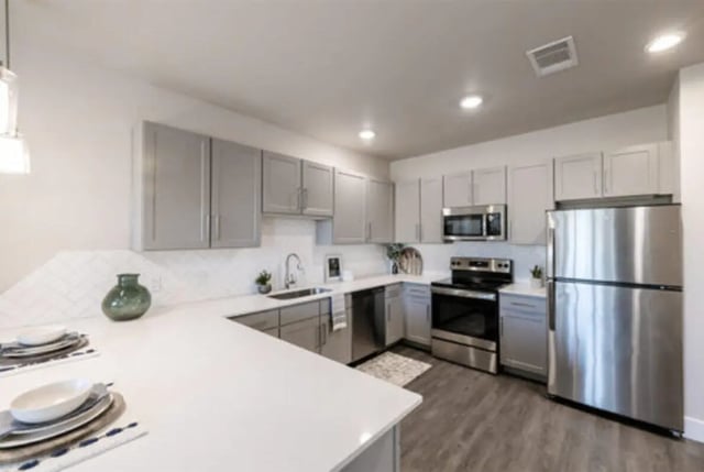 Modern kitchen with stainless steel appliances and grey cabinets Kitchen at The Carlton House in Lubbock Student Accommodation