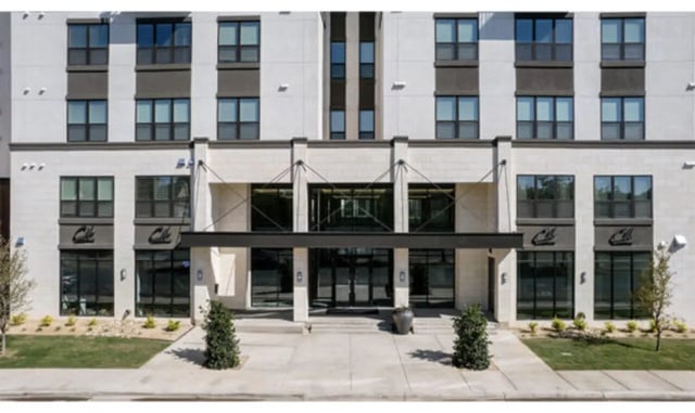 Modern building entrance with large windows and exterior exterior at The Carlton House in Lubbock Student Accommodation