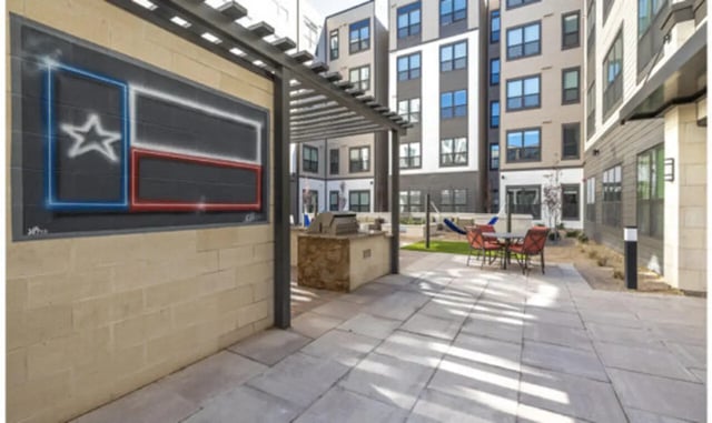 Texas flag art grill table chairs exterior at The Carlton House in Lubbock Student Accommodation
