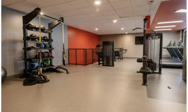Gym equipment weights and treadmills workout area at The Carlton House in Lubbock Student Accommodation