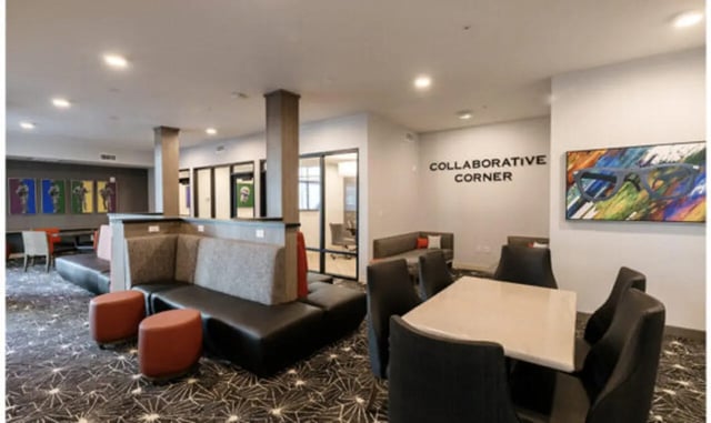 Lounge seating and tables with artwork communal area at The Carlton House in Lubbock Student Accommodation