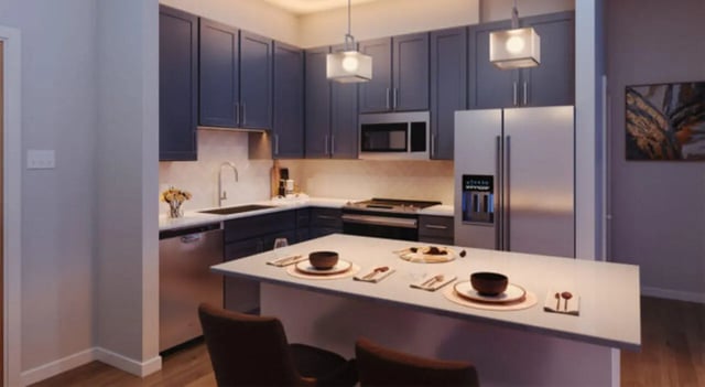 Modern kitchen with island refrigerator microwave cabinets kitchen at The Carlton House in Lubbock Student Accommodation